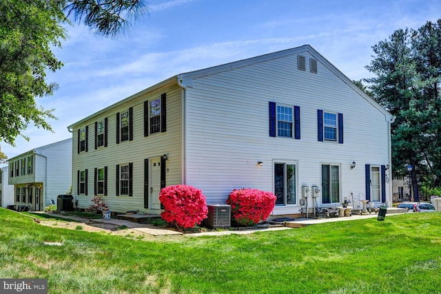 exterior space featuring a patio, a yard, and cooling unit