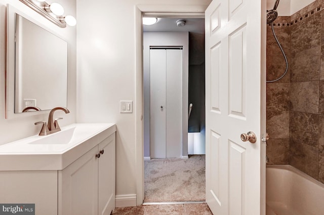 full bath featuring vanity, baseboards, and bathtub / shower combination