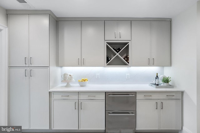 bar featuring visible vents and tasteful backsplash