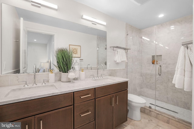 full bath featuring double vanity, a shower stall, and a sink