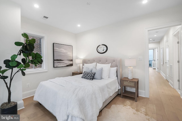 bedroom featuring visible vents, recessed lighting, baseboards, and light wood-style floors