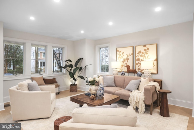 living room featuring recessed lighting, baseboards, and light wood-style floors