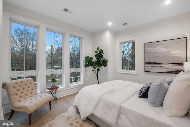 bedroom with recessed lighting, visible vents, multiple windows, and wood finished floors