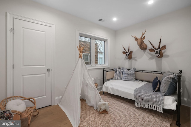 bedroom featuring recessed lighting, light wood-style floors, and visible vents