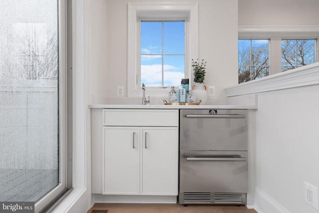 bar featuring dishwasher and a sink