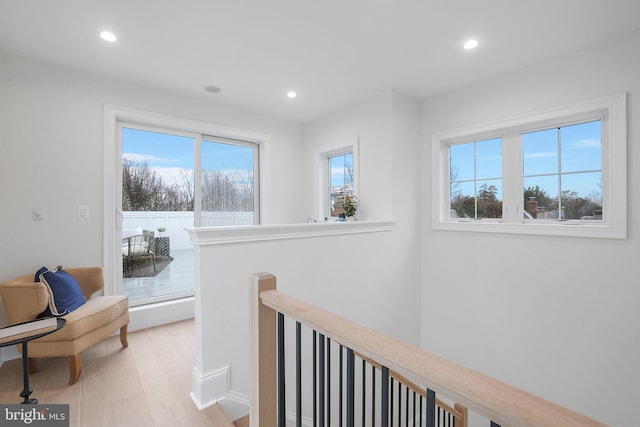 hallway featuring recessed lighting, an upstairs landing, and light wood-type flooring