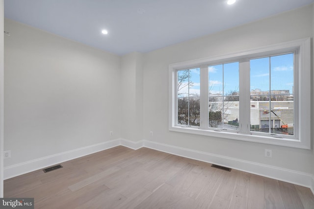 empty room with baseboards, visible vents, and a wealth of natural light