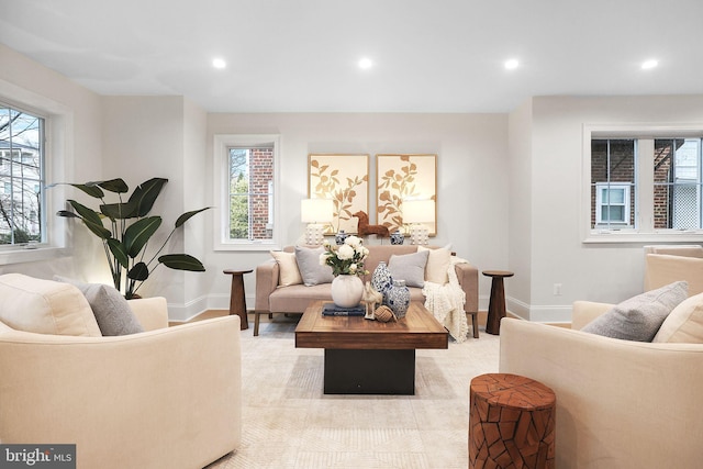 living room featuring recessed lighting, baseboards, and a wealth of natural light