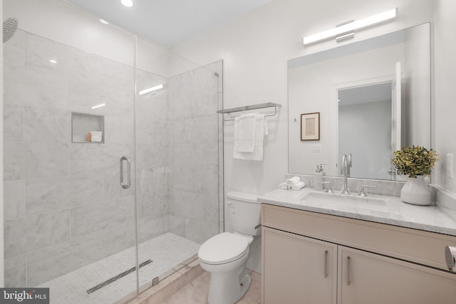 full bathroom with vanity, toilet, and a shower stall