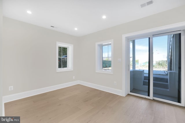 empty room with recessed lighting, visible vents, baseboards, and light wood-style floors