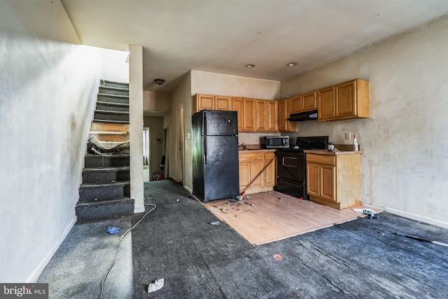 kitchen with under cabinet range hood and black appliances