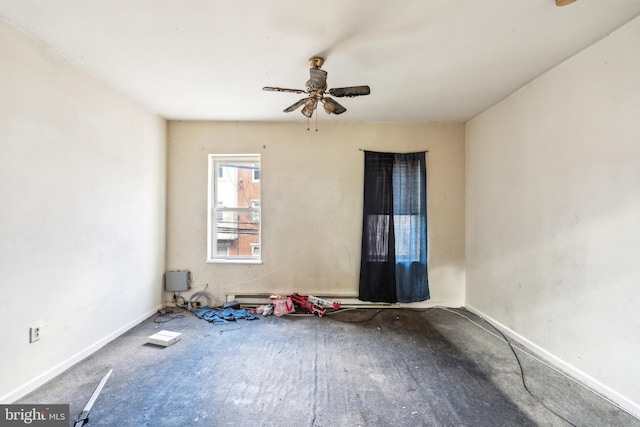 spare room featuring ceiling fan and baseboards