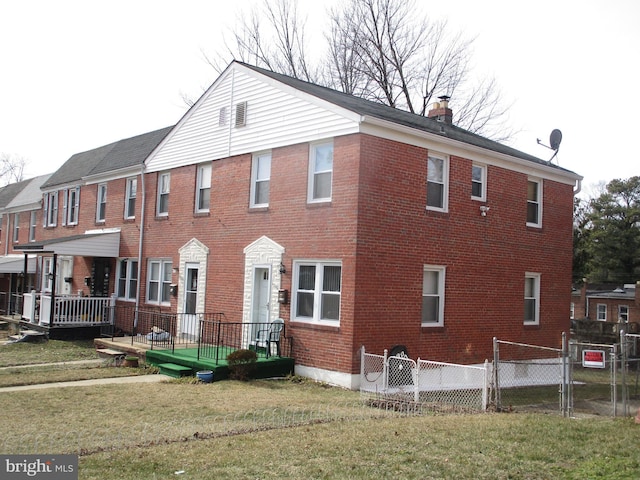 exterior space featuring brick siding, a chimney, a front yard, a gate, and fence