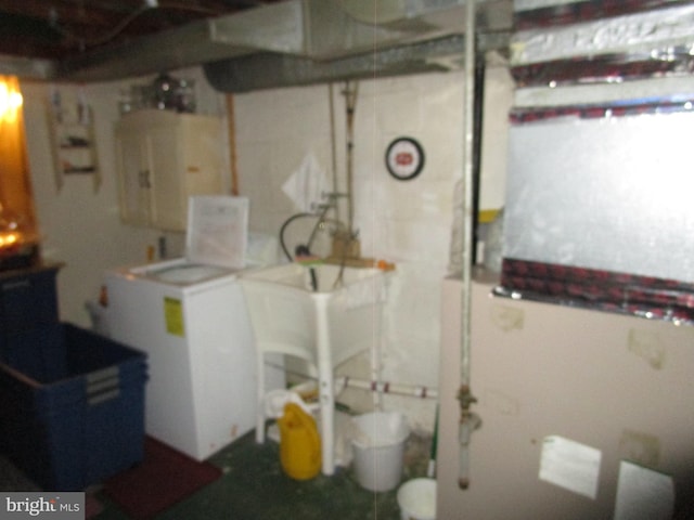 unfinished basement with washer / dryer