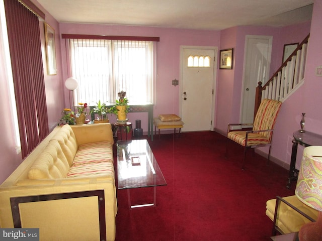 living room with baseboards and stairway