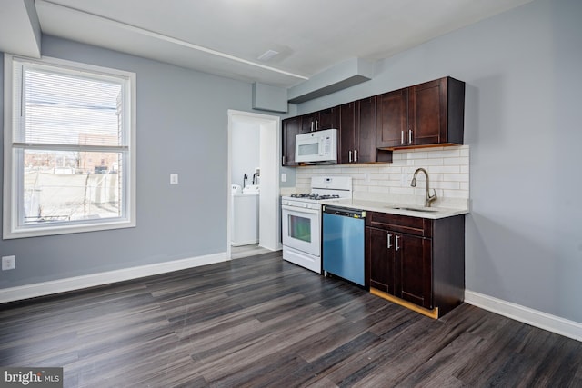 kitchen with white appliances, a sink, baseboards, tasteful backsplash, and dark wood finished floors