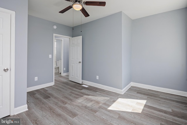 unfurnished bedroom with ceiling fan, baseboards, and wood finished floors