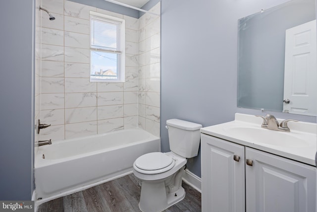 full bath featuring baseboards, toilet, shower / tub combination, wood finished floors, and vanity