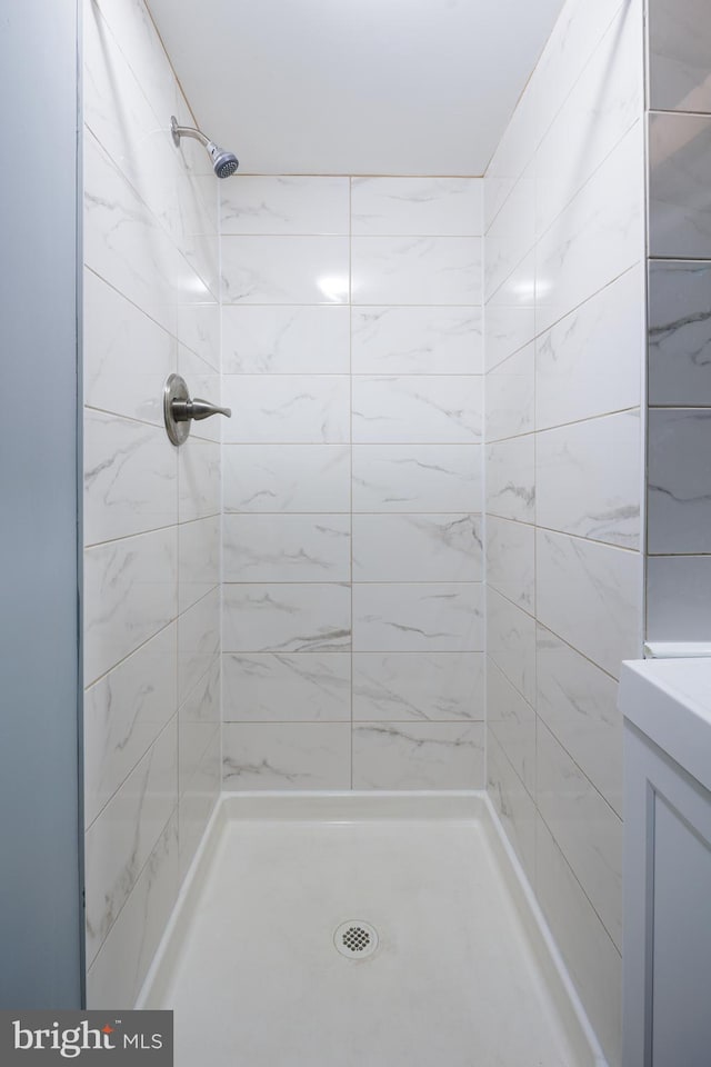 full bathroom featuring a shower stall and vanity