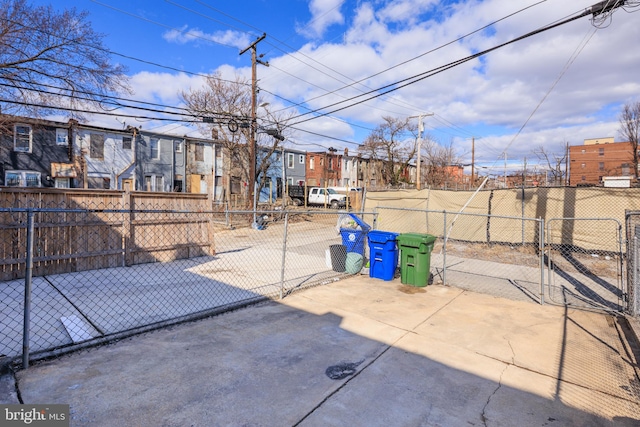 view of patio / terrace with a gate, fence, and a residential view