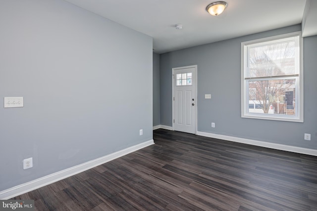 entryway with dark wood-type flooring and baseboards