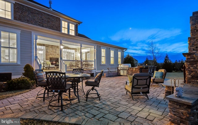 view of patio with area for grilling and a grill