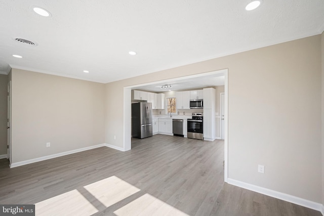 unfurnished living room featuring light wood-style floors and baseboards