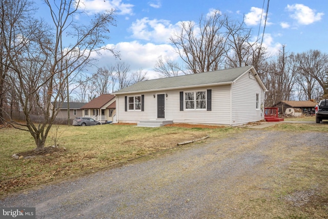 single story home with driveway and a front yard