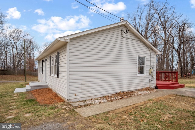 view of property exterior with a wooden deck