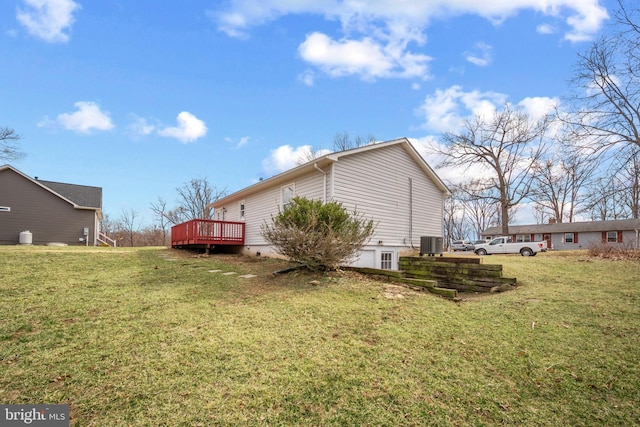 view of side of property with cooling unit, a lawn, and a deck