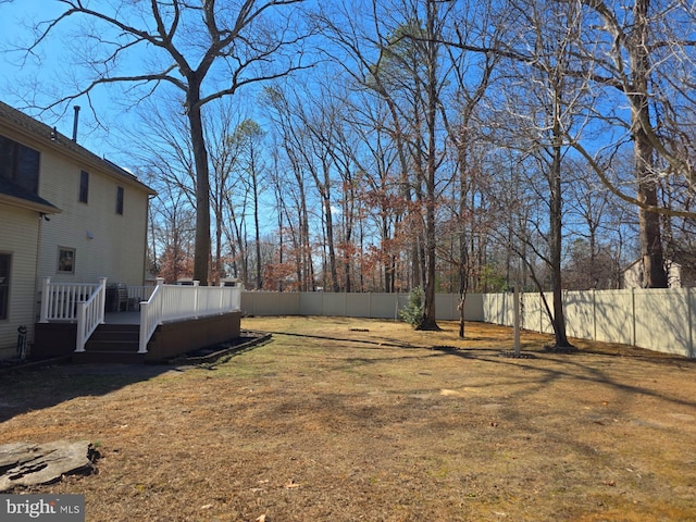 view of yard with fence private yard and a deck