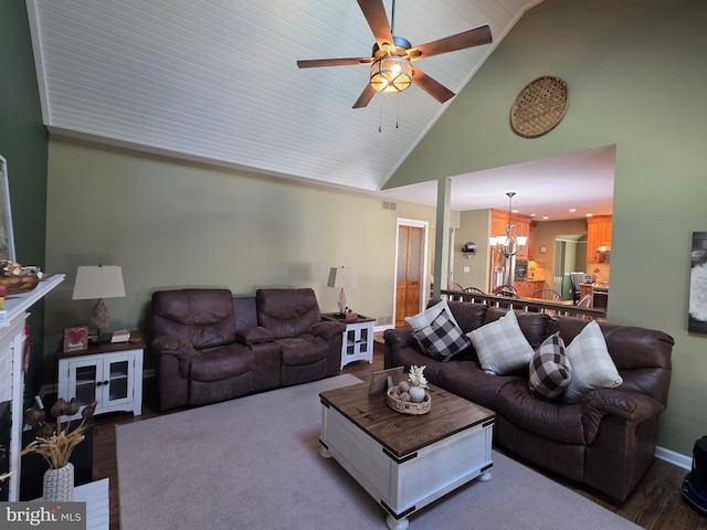 living area with visible vents, high vaulted ceiling, wood finished floors, and ceiling fan with notable chandelier