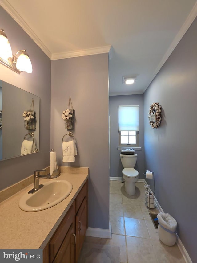 half bath with toilet, baseboards, ornamental molding, and vanity