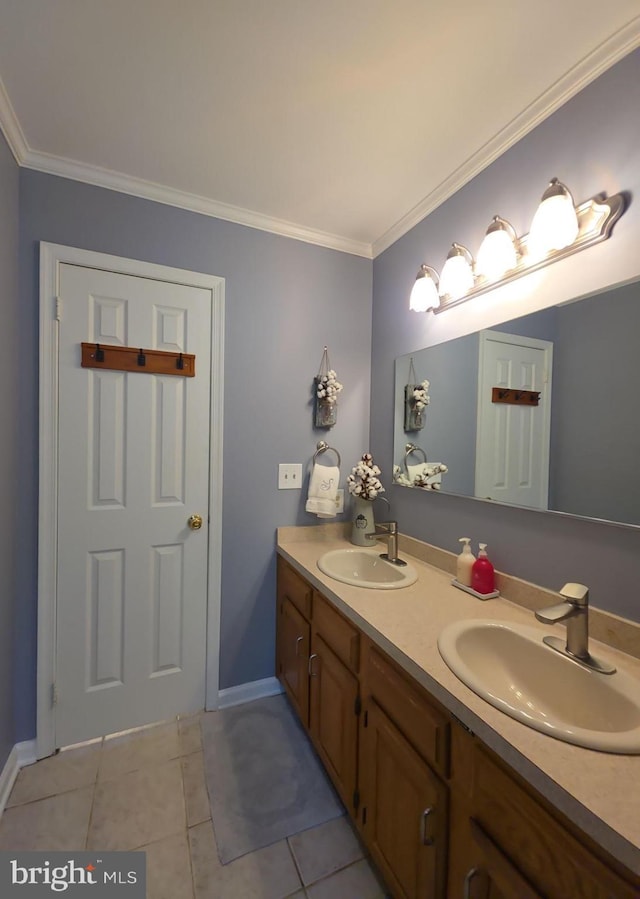 bathroom with tile patterned flooring, crown molding, and a sink