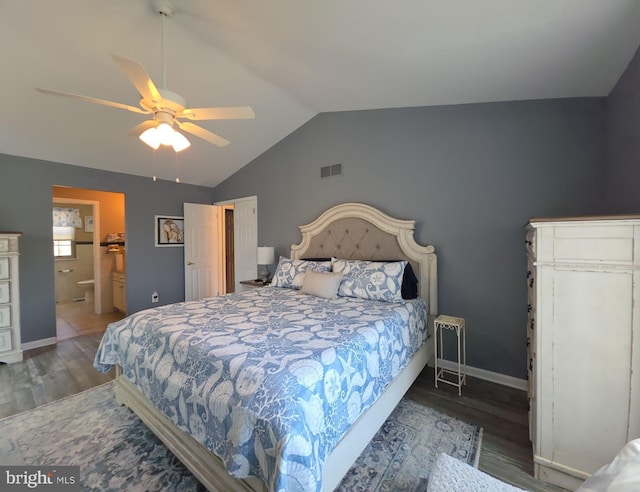 bedroom with lofted ceiling, wood finished floors, visible vents, and baseboards