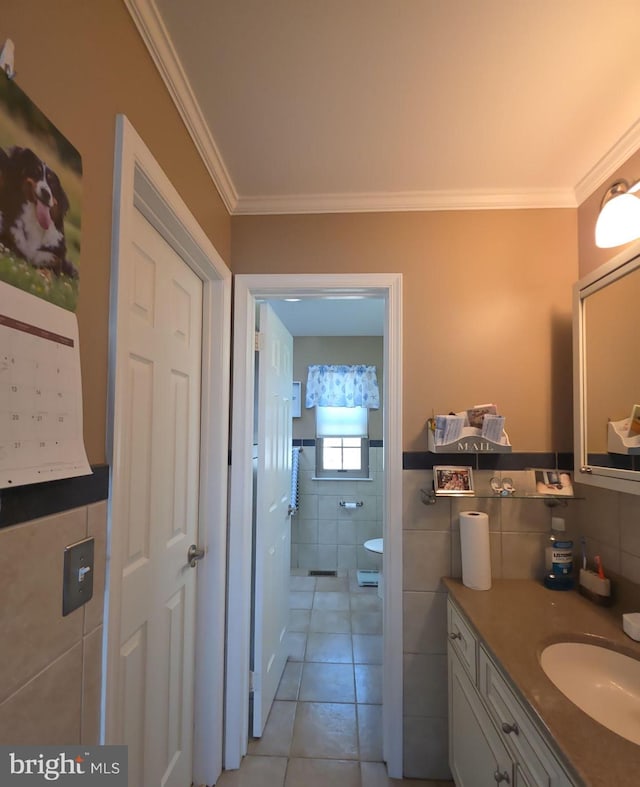 bathroom featuring ornamental molding, tile walls, vanity, and tile patterned floors