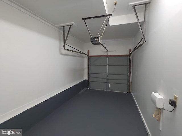 garage featuring a garage door opener and baseboards