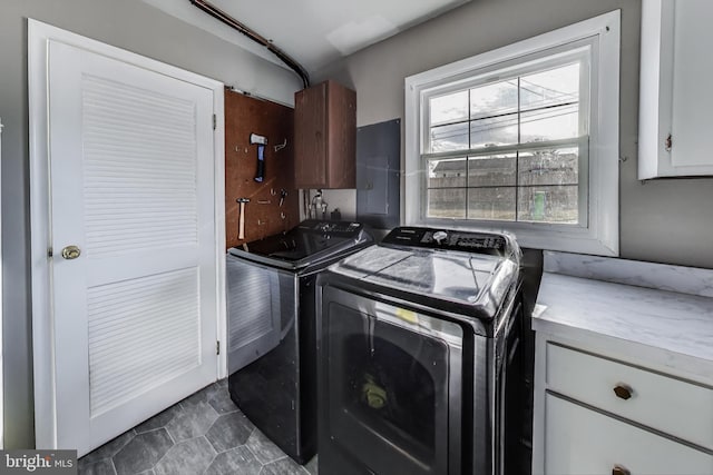 laundry room featuring cabinet space and washer and clothes dryer