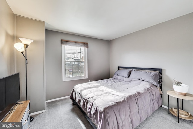 carpeted bedroom featuring baseboards