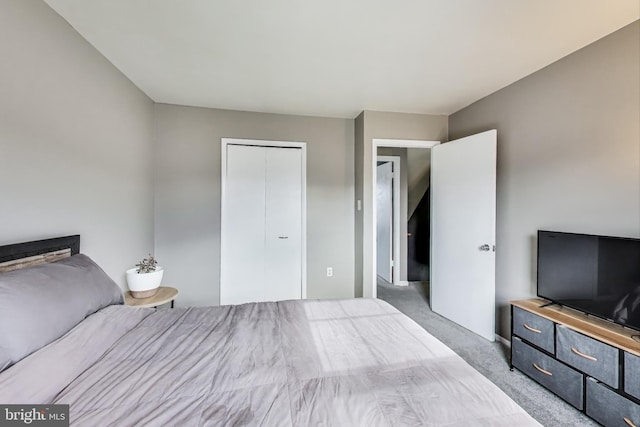 bedroom featuring a closet and carpet flooring