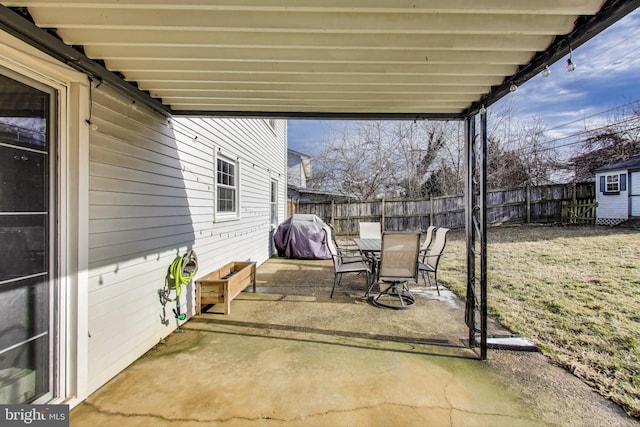 view of patio featuring outdoor dining space, area for grilling, and fence