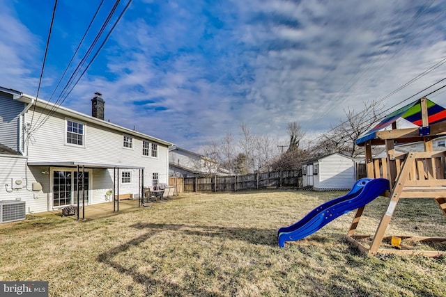 view of yard featuring a fenced backyard, cooling unit, a playground, and a patio