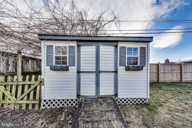 view of shed with fence