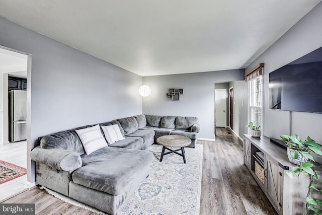 living room featuring baseboards and wood finished floors