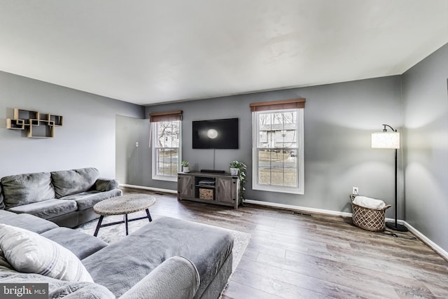 living room featuring baseboards and wood finished floors