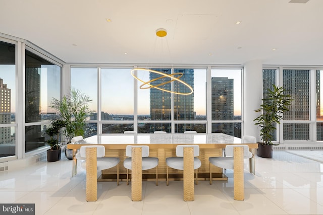 sunroom with a healthy amount of sunlight, a notable chandelier, and a city view