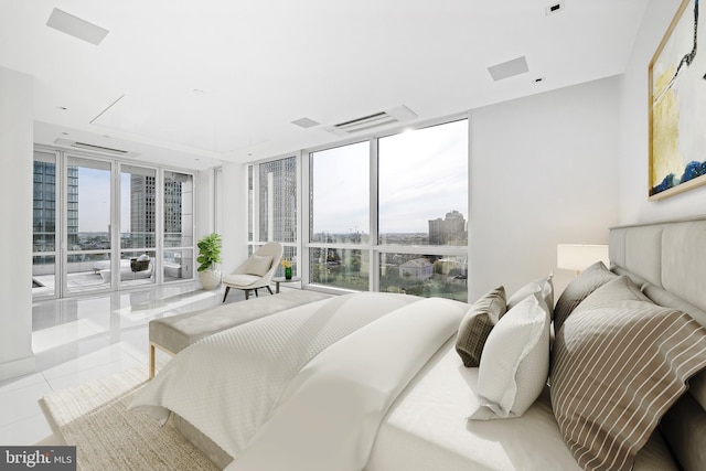 bedroom with expansive windows, access to outside, tile patterned flooring, and multiple windows