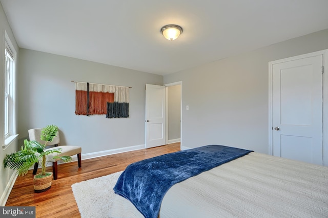 bedroom featuring baseboards and wood finished floors