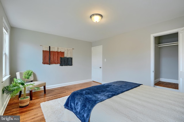 bedroom featuring baseboards and wood finished floors