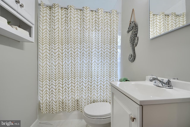 bathroom with toilet, a shower, and vanity